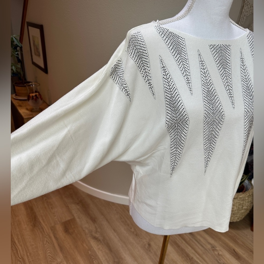 Festive cream sweater with contemporary sparkle icicles or diamonds.